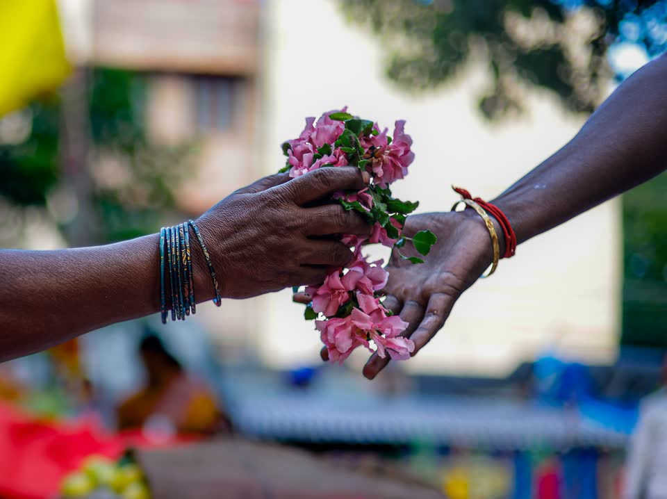 Fresh flowers passed from one hand to another